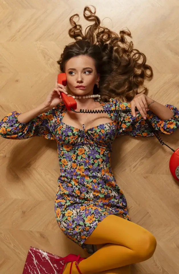 Leżąca kobieta rozmawiająca przez telefon.